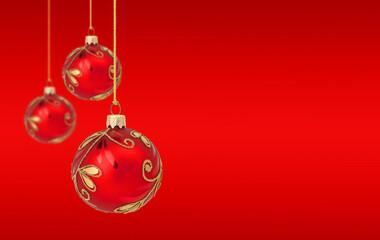 Hanging Christmas ornaments on red background with copy space