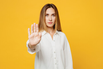Young strict serious sad caucasian woman she wear white shirt casual clothes showing stop gesture...