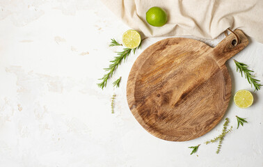 Empty wooden round board on white stone kitchen table top