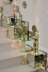 The interior of a room decorated for the holiday. Mirror cubes, garlands and Christmas tree balls