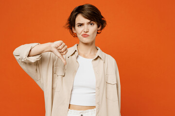 Young sad disappointed displeased caucasian woman she wearing beige shirt casual clothes showing...