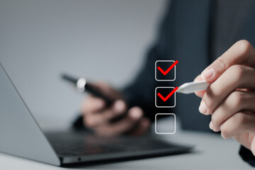 Online business assessment survey concept. Businessman doing checklist and takes an online...