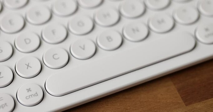 Woman finger presses the spacebar button on computer keyboard. Computer use and programming