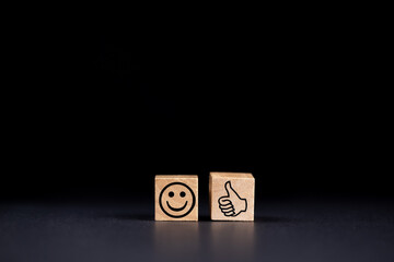 a smiling face icon marked with a hand with thumb up on black background