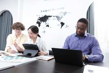 Teamwork creative graphic designer selecting color swatch samples idea using laptop at modern office. Creative startup corporate color product branding design.