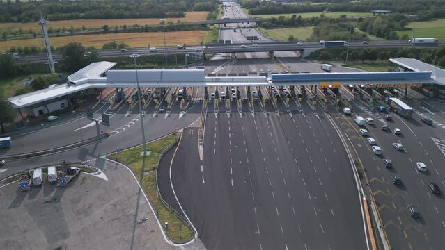 Aerial view of an Italian highway toll booth. Time-lapse cars queuing up to pay the highway toll and automatic paying lanes.