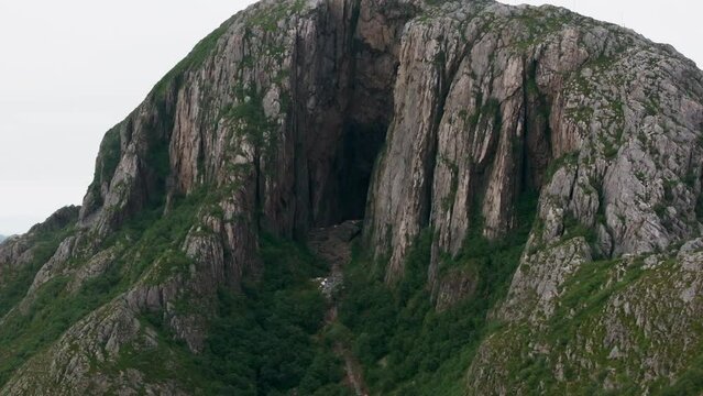 Dark mystical hole through Torghatten mountain in Norway; drone