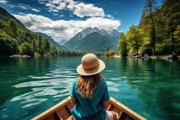 Foto op Canvas Summer vacation concept, happy girl in hat relaxing on a boat on a mountain lake © VIK