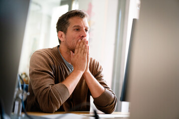 Overworked tired employee, programmer at workplace in office being unhappy