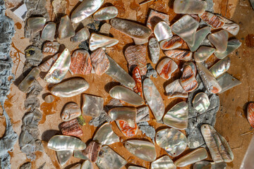 making grass and shell jewellery with tools in a workshop