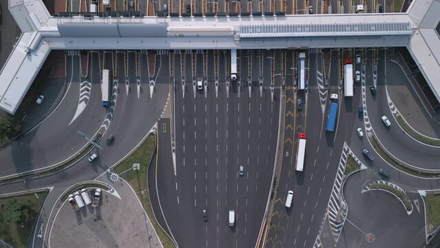 Aerial view of an Italian highway toll booth. Time-lapse cars queuing up to pay the highway toll and automatic paying lanes.
