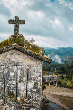 Espigueiros (H&oacute;rreos). Typical stone corn dryers (racecards or granaries lifted to be protected against rodents) crowned with crosses on the stone hill in Soajo. Peneda-Geres park. Minho, Portugal