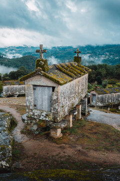 Espigueiros (H&oacute;rreos). Typical stone corn dryers (racecards or granaries lifted to be protected against rodents) crowned with crosses on the stone hill in Soajo. Peneda-Geres park. Minho, Portugal