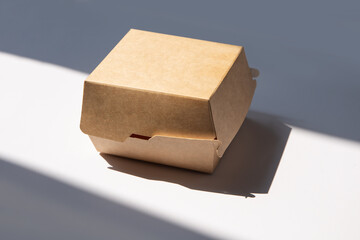 Closed blank disposable brown paper burger box isolated on white