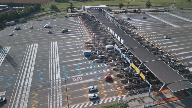Aerial view of an Italian highway toll booth. Time-lapse cars queuing up to pay the highway toll and automatic paying lanes.
