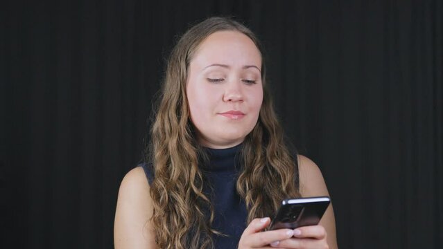 Woman texting on phone looks up talking then back at phone lips flare out then relaxes mouth