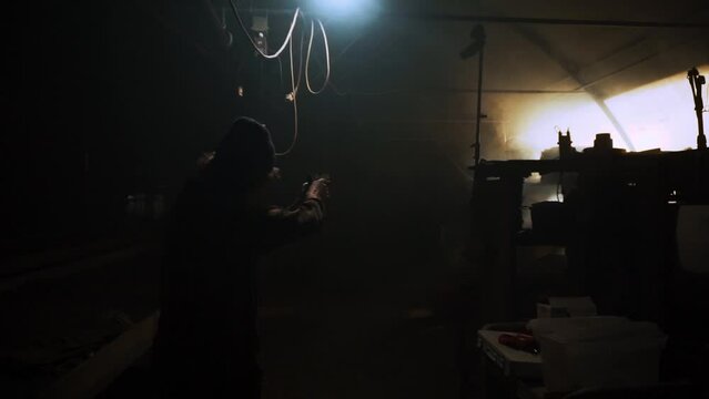 Guy walking through room with gun