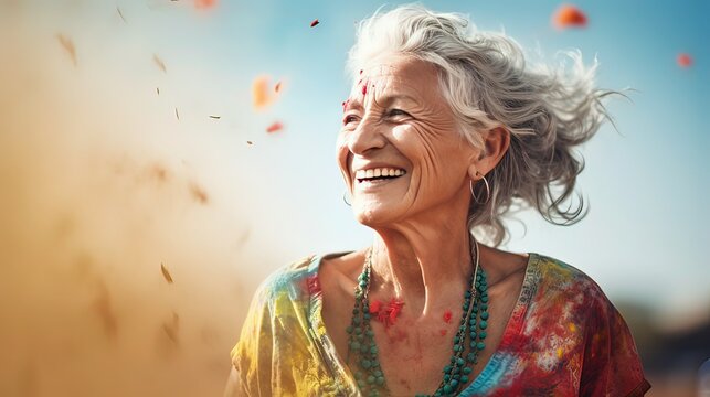 elderly woman having fun at Holi festival
