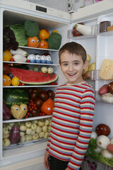 Content of open refrigerator. Organic food, fruits, vegetables. Rainbow food, products in fridge, refrigerator. Healthy nutrition. Multicolored nutrition for vegetarian. Color diet. Happy child. Eat