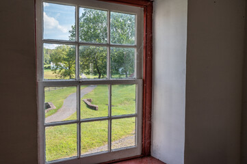 View of idyllic countryside through antique twelve pane window