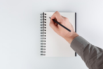 business notepad, hand holding a pencil on a white background