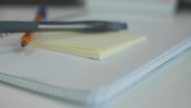 Notebook, pen and eraser in slow motion