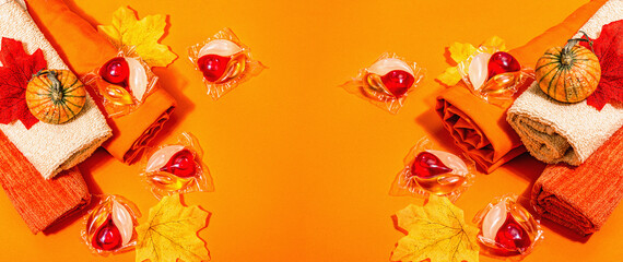 Machine washing concept. Capsules with detergent, soft towels and autumn decor. Laundry pods