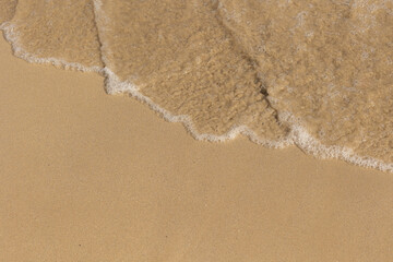 Sea shore with breaking wave view from above