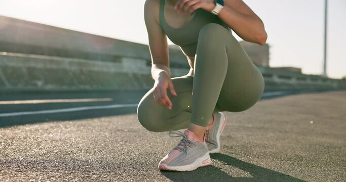 Tying laces, fitness and a woman in the city for running, sports or training in the street. Health, hiking and a runner or female athlete getting ready for exercise, marathon or cardio with shoes
