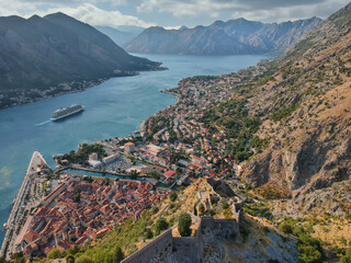Fototapeta na wymiar Aerial view on town of Kotor and its Fortress, with sorrounding mountains and bay