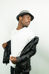 Portrait of a young black man wearing a hat against white background