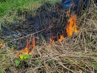 fire was burning in the dry grass on the side of the road.