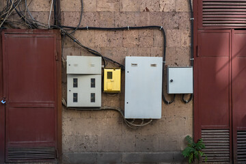 Power shields on facade of building. Wall of house with electrical equipment. Transformer building....