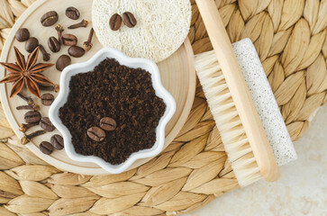 Wooden foot brush with pumice stone and homemade exfoliating foot scrub with ground coffee, star anise and clove. Natural pedicure recipe. Top view.