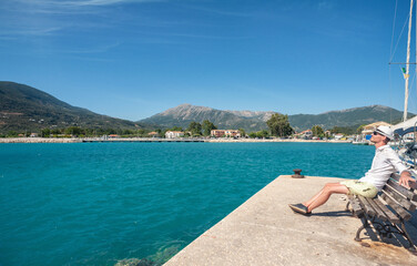 A tourist is enjoying his vacation in Greece by the Ionian sea