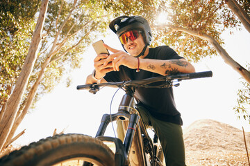 Bicycle, exercise and man with a cellphone, typing and connection with blog, influencer and social...