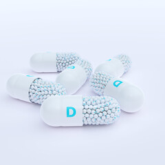 Vitamin D With White Capsules, Granules and White Background