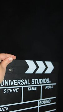 vertical video of clapper board dark background