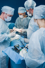 Team of surgeons doing operation in hospital