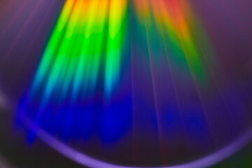 Abstract light beams filtering from surface into deep blue in rainbow burst