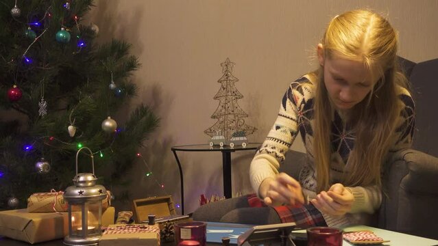 Girl wrapping Christmas gifts