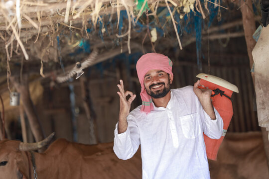 happy Indian farmer selling milk in farm