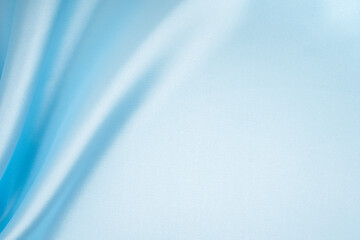 Light blue crumpled silk fabric texture background.
