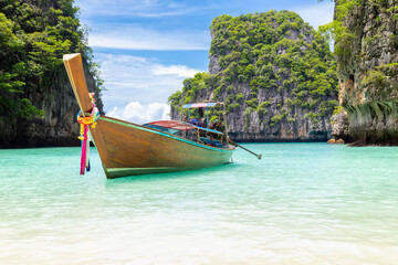 The Thai traditional wooden longtail boat and beautiful beach in Phuket province, Thailand.