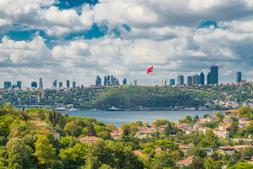 Giant Turkish flag and business center skyscrapers on the edge of the Bosphorus in a cloudy weather