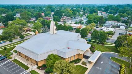 Aerial St Jude Catholic church with view of neighborhoods on summer day