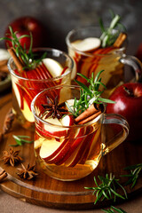 Christmas mulled apple cider with cinnamon, anise and rosemary. Traditional hot drink or beverage, festive Xmas or New Year winter cocktail
