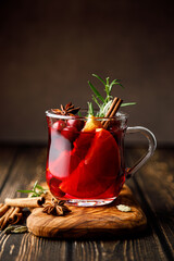 Christmas mulled wine with cranberry, orange, cinnamon, anise and rosemary. Traditional hot drink...