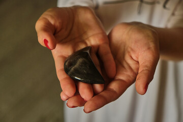 Woman Holding a different natural magic massage stones with both hands
