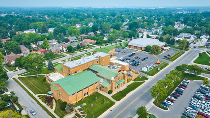 Aerial wide view of St Jude Catholic church and school with school windows under construction